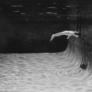 Woman Swimming Towards Ladder