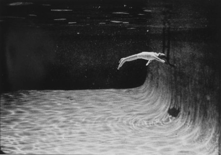Woman Swimming Towards Ladder
